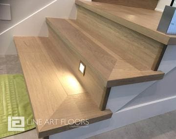 Modern wooden stairs with built-in LED lighting for safety and style.