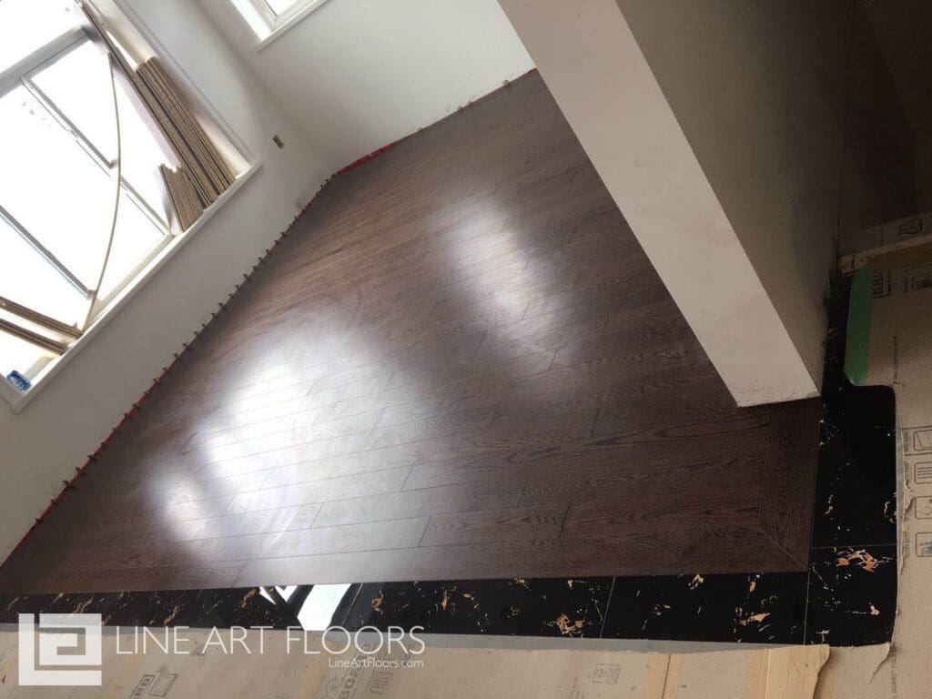 Polished dark hardwood floor in a sunlit room.