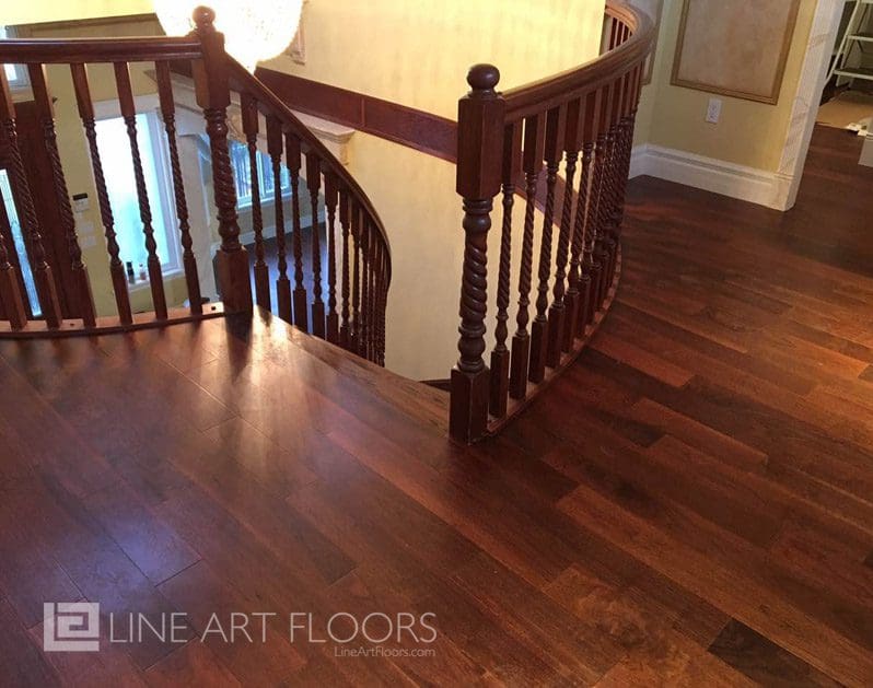 Elegant wooden staircase with polished hardwood flooring.