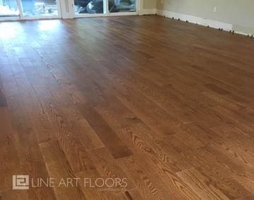 Smooth, polished hardwood flooring in a sunlit room.