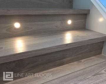 Modern wooden stairs with built-in lighting for safety and aesthetics.